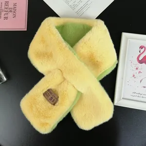 Detail of two-tone faux rabbit fur scarf in yellow and green with brand label