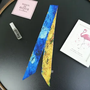 Close-up of Van Gogh oil painting style narrow silk scarf on a stylish vanity setup