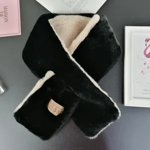 Close-up of bicolor faux rabbit fur scarf with premium leather brand label detail