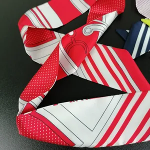 Red and white polka dot silk scarf with stripes and geometric patterns on black background