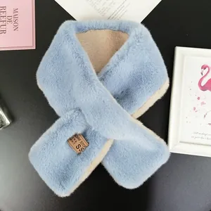 Detail shot of plush faux rabbit fur scarf in light blue with beige lining and logo patch