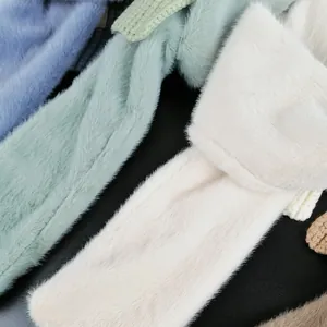 Detailed close-up of soft knitted faux rabbit fur scarves in various pastel colors