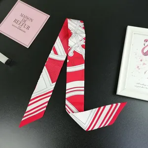 Detailed view of red and white polka dot silk twilly scarf with vintage hardware patterns