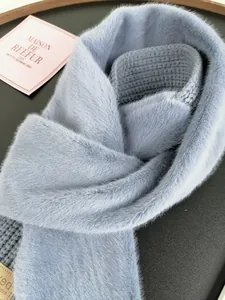 Detail of light blue faux fur scarf showing soft plush texture and leather brand tag