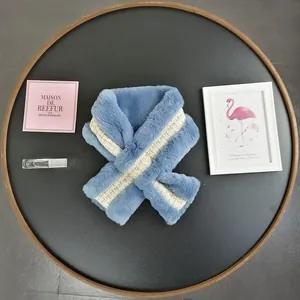 Detail of blue faux rabbit fur scarf with a white and gold plaid woven cross strap