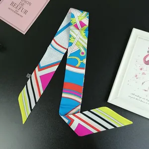 Detailed close-up of a colorful patterned silk twilly scarf with polka dots and stripes