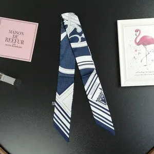 Detail showing navy and white polka dot silk twilly with French architecture design
