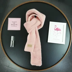 Detail of pink knitted scarf with soft faux fur texture and Beloved logo tag