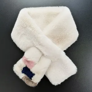 Detailed macro view of plush faux fur scarf showing tri-color accent on white faux rabbit fur