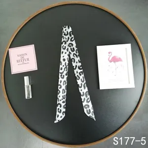 Detail of black and white leopard print skinny scarf used for handbag handle decoration