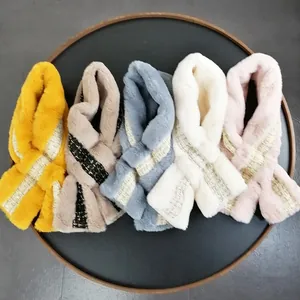Plush faux rabbit fur scarves in five colors with glitter cross bands on wooden tray