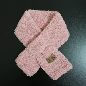 Detailed view of pink plush scarf featuring a soft lambswool texture and stitched label