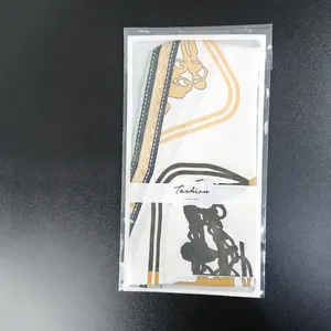 Silk-like decorative neck scarf with chain pattern in golden yellow and black colors