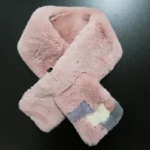 Detail of soft pink faux rabbit fur scarf featuring geometric color-block patterns