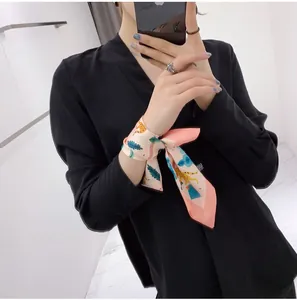 Detailed texture of pink floral silk scarf with tropical leaf prints and leopard pattern
