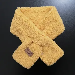 Detail of yellow plush fleece scarf with soft texture and Korean style woven tag