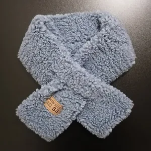 Winter warm grey-blue faux lamb wool scarf with a cross-over design and brand label