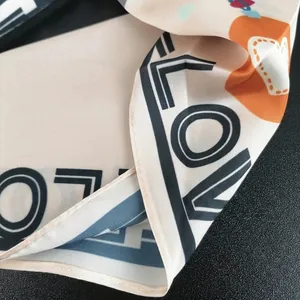 Elegant silk scarf with orange heart and LOVE print featuring premium edge stitching