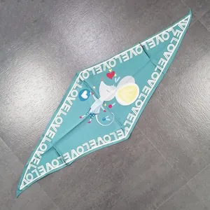 Detail of teal silk scarf featuring a cartoon mouse pattern and Love lettering border