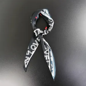 Close-up of black silk scarf featuring white LOVE text and red heart pattern detail