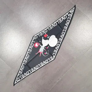 Detail of a black diamond-shaped silk scarf featuring a cartoon mouse and LOVE border