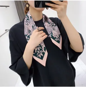 Detail of silk-feel skinny scarf featuring pink tiger and floral print on dark green