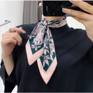 Detail of floral silk scarf with tiger and palm leaf pattern tied on neck