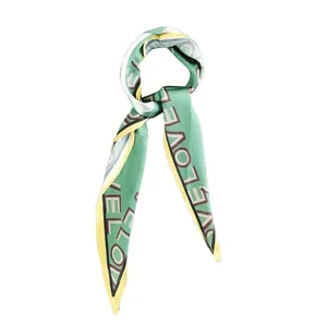 Long silk scarf in mint green and yellow with geometric LOVE print design