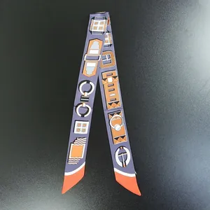 Detailed macro view of gray silk twilly scarf with horse harness patterns for handbags