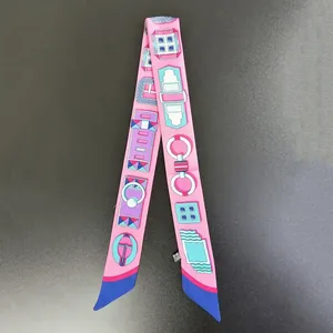 Macro shot of pink silk twilly scarf featuring geometric horse bit pattern design