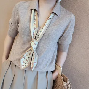 French minimalist floral skinny scarf styled with a camel knit polo shirt and trousers
