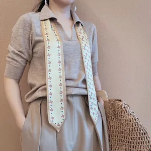 Elegant narrow skinny scarf with cherry print, styled with a polo shirt and knitwear