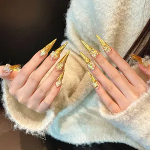 Luxurious long stiletto press-on nails with golden foil and glittering 3D crystal accents