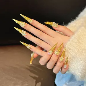 Luxurious extra-long stiletto gold nails with glitter and metallic coating textures
