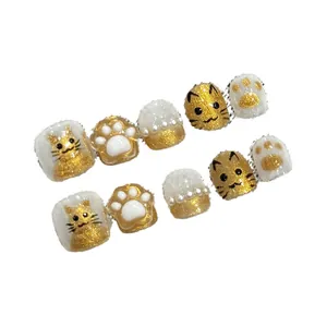 Handmade press-on nails for kids with golden 3D cat and paw designs with pearls