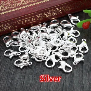 Bulk silver lobster claw clasps for DIY jewelry making on dark wood background