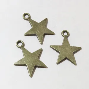 Macro view of three vintage bronze star charms with rings for DIY jewelry making