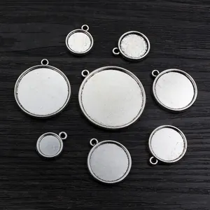 Set of 8 vintage silver alloy DIY pendant trays in various sizes for jewelry making