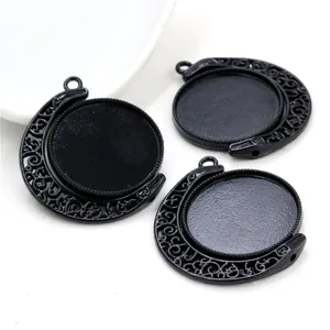 Close-up of rotating black alloy 25mm pendant trays with crescent hollow patterns