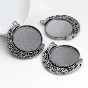 Detailed view of gunmetal and silver rotating moon-shaped alloy pendant trays for DIY jewelry