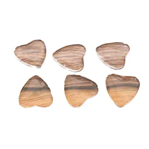 Set of six heart-shaped guitar picks with polished brown wood grain finish on white back