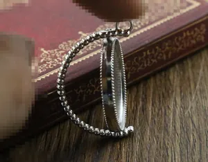 Macro shot of silver rotating alloy pendant base with beaded trim for DIY jewelry