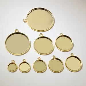 Detailed macro view of nine golden stainless steel pendant base settings for DIY jewelry