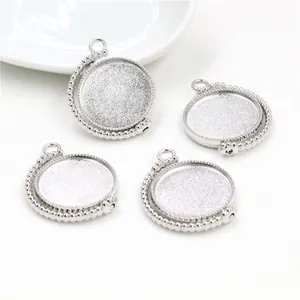 Set of four silver rotating pendant trays with beaded edges for DIY jewelry making