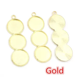 Three gold alloy DIY jewelry pendant trays with textured borders and radial patterns