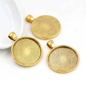 Detailed view of three gold round cabochon settings with textured radial pattern