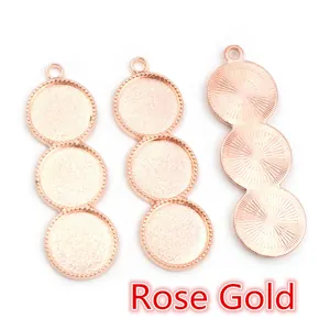 Detail of three rose gold DIY pendant trays with beaded edges and 12mm round settings