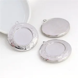 Detailed view of round 20mm copper locket pendant with intricate floral engraved edges