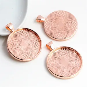 Close-up of three 30mm round rose gold bezel trays with internal grid texture