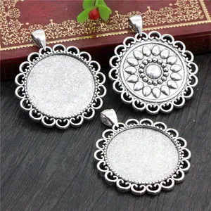 Detailed view of vintage silver alloy pendant trays and sunflower embossing on wood